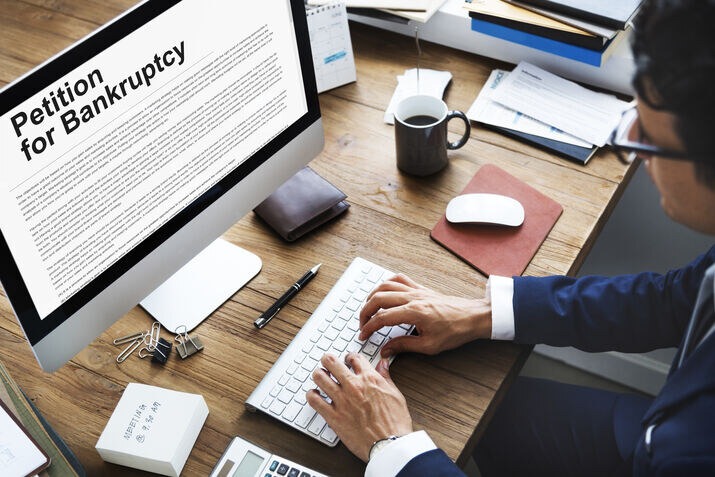 Business owner completing trademark renewal documents on a computer