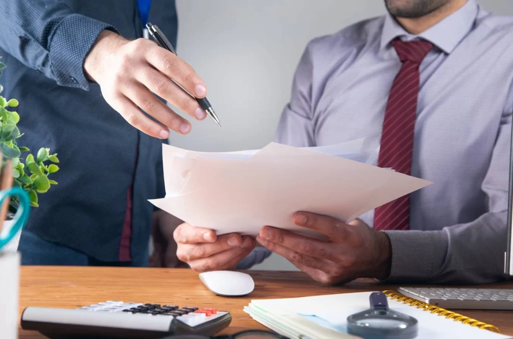 Business professionals discussing trademark transfer legal process
